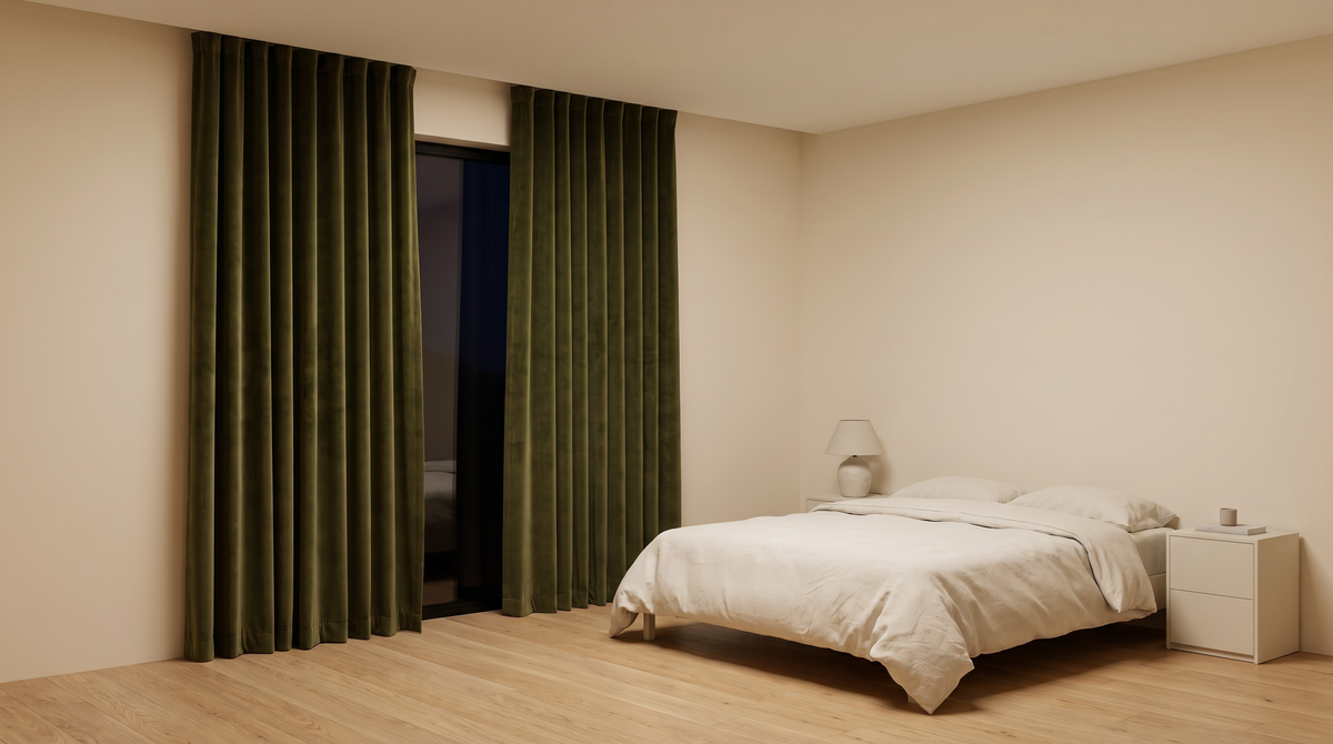 Hush Velvet Blackout olive velvet curtains styled at a window in a calm bedroom