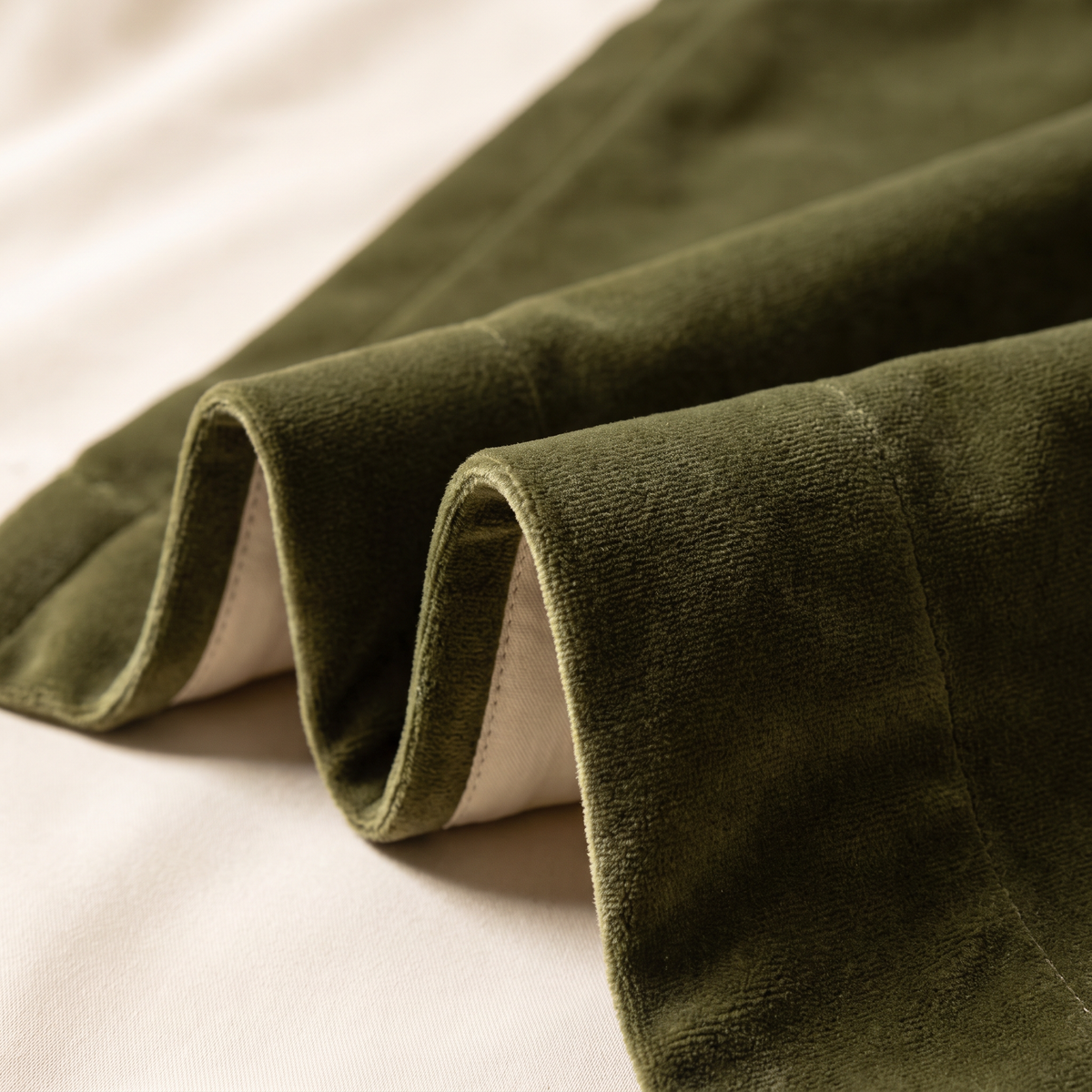 Close-up of Hush Velvet Blackout olive cotton velvet pile with cream blackout lining