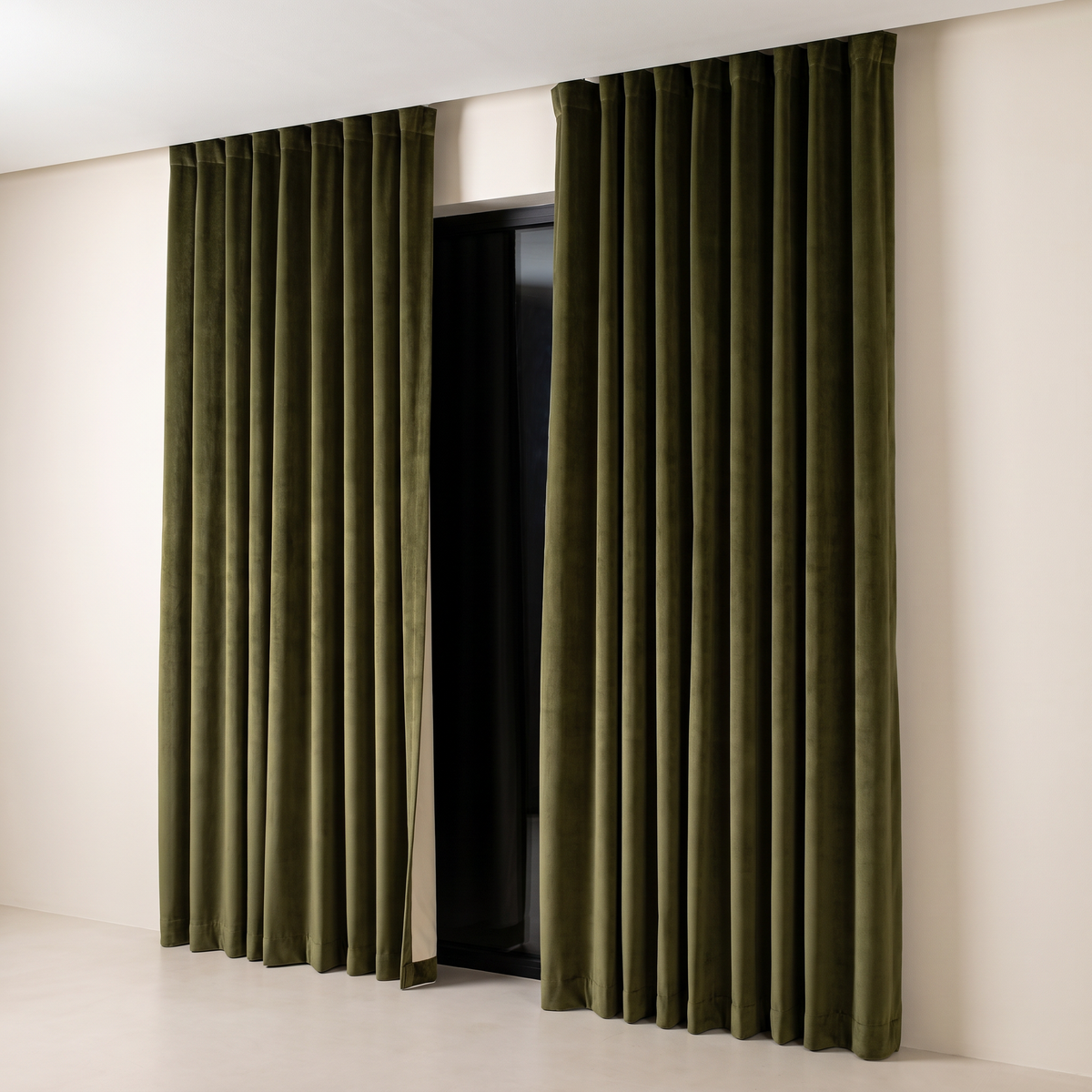 Hush Velvet Blackout curtains in deep olive cotton velvet with ripple folds from a ceiling track, front three-quarter view