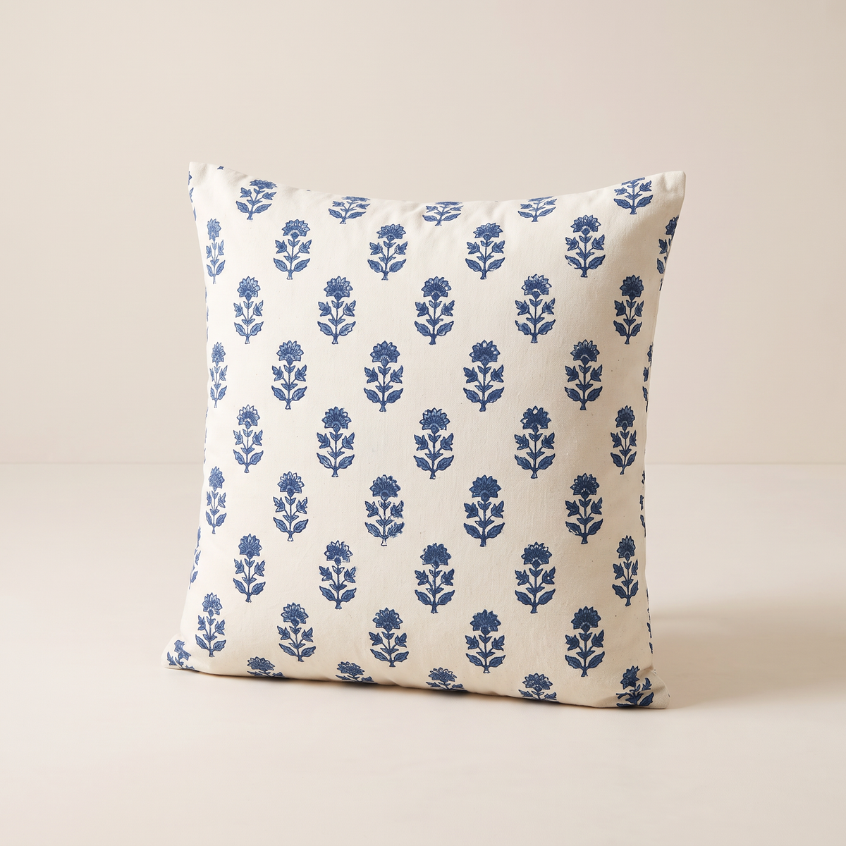 Indigo Buti Cushion in off-white cotton block-printed with small indigo floral sprigs, front three-quarter view