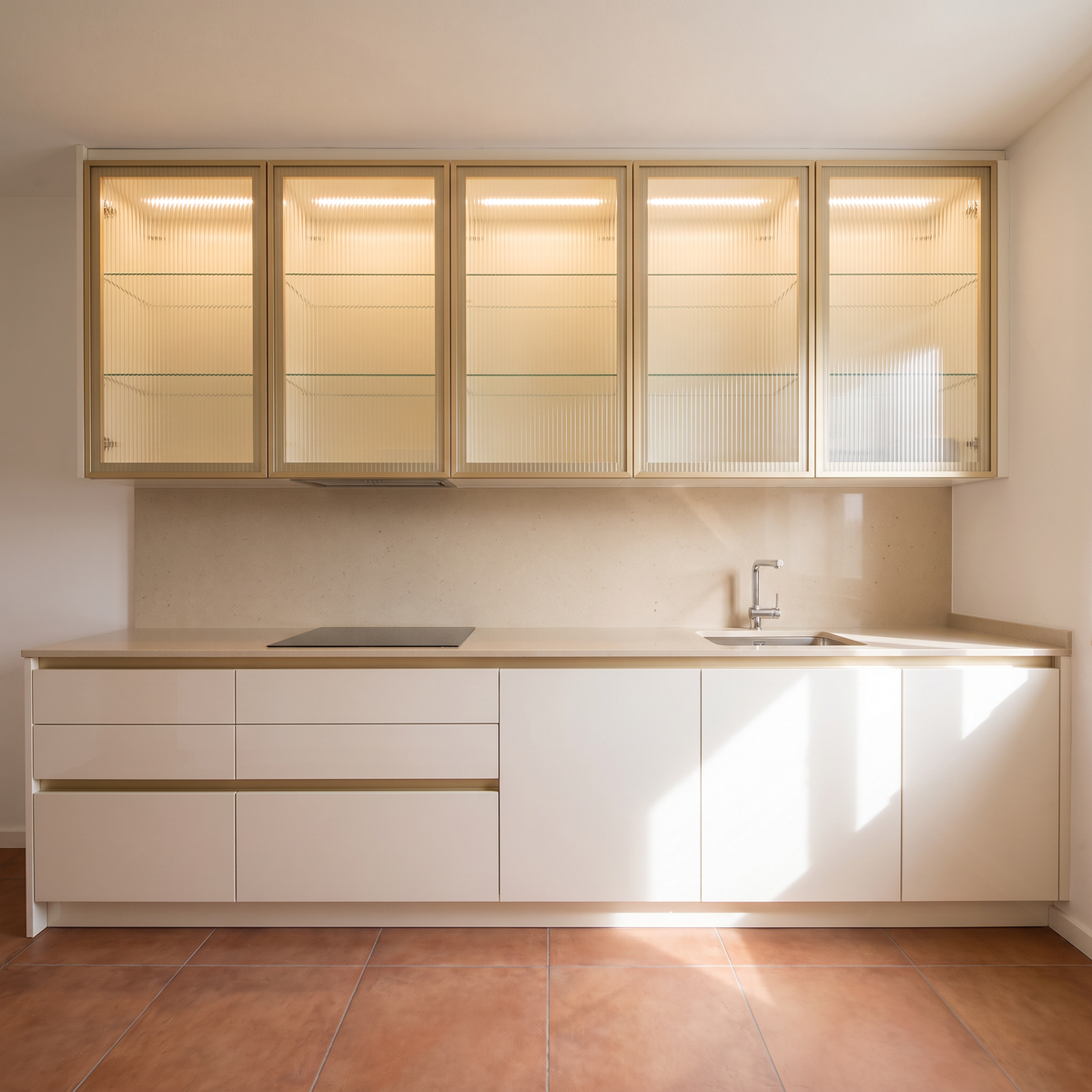 Juniper Galley hob and sink run with lit fluted-glass wall cabinets and beige quartz worktop, straight front elevation