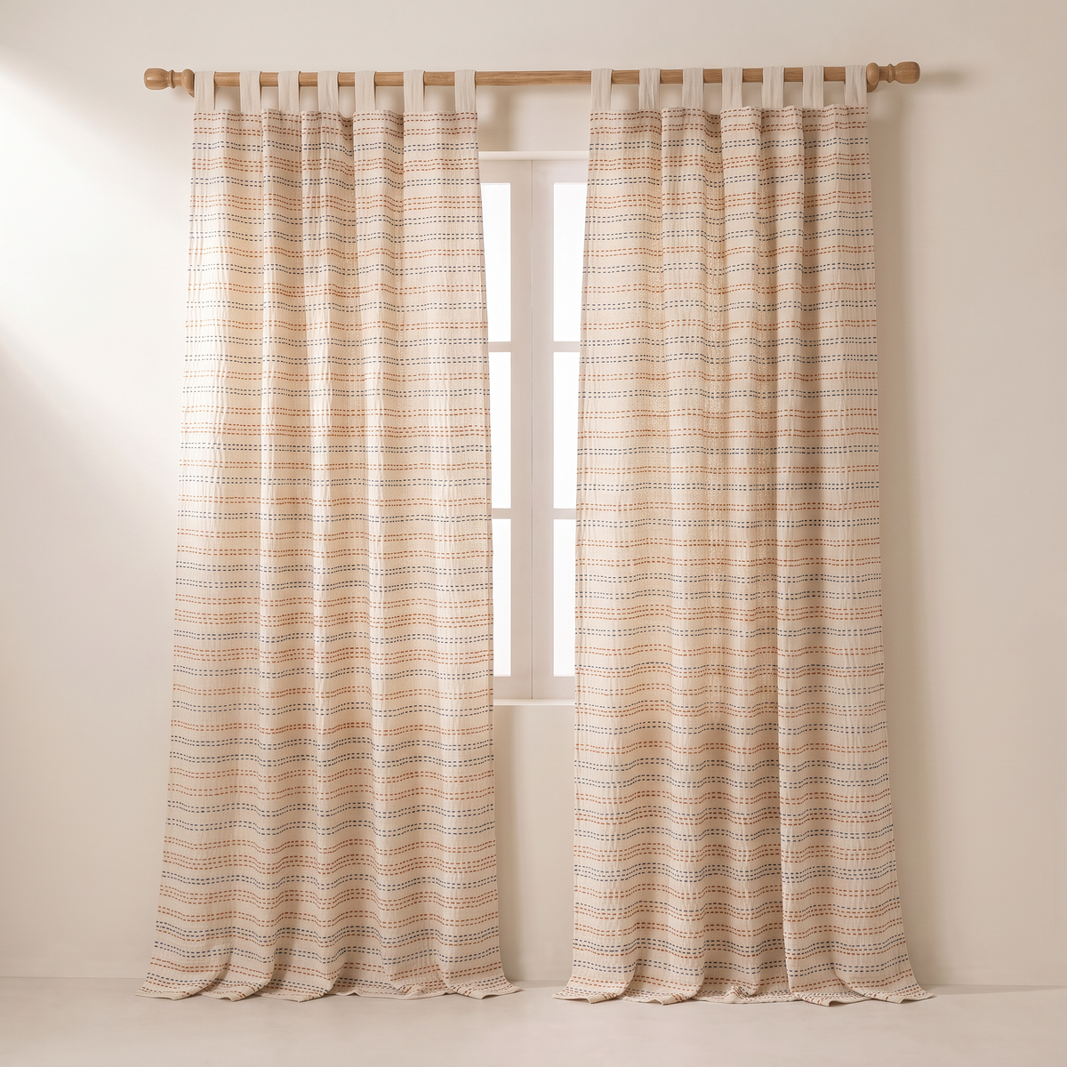 Kantha Stitch ivory cotton curtains on a wooden rod, straight front view