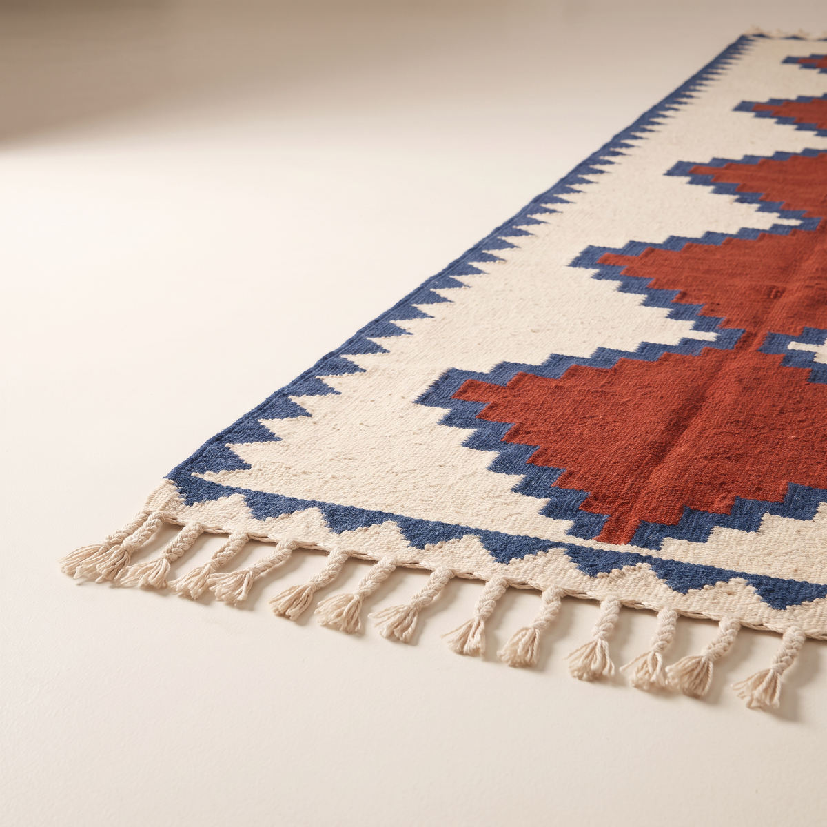 Kilim Runner corner close-up showing the flat wool weave, indigo border and braided tassels