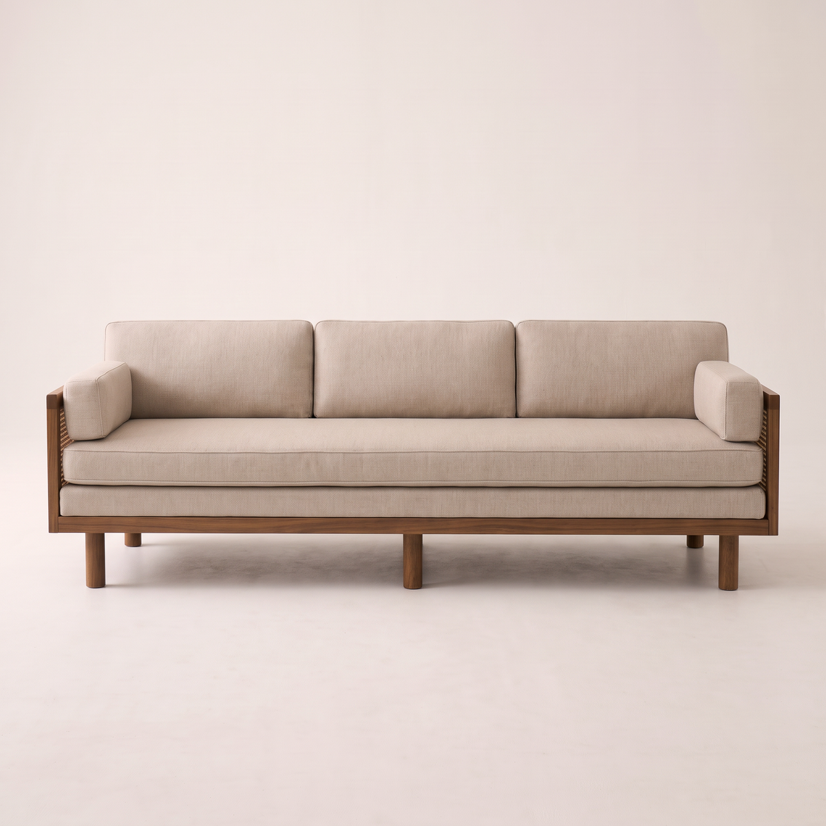 Kora Cane sofa with wooden frame, cane arm panels and oatmeal upholstery, front view