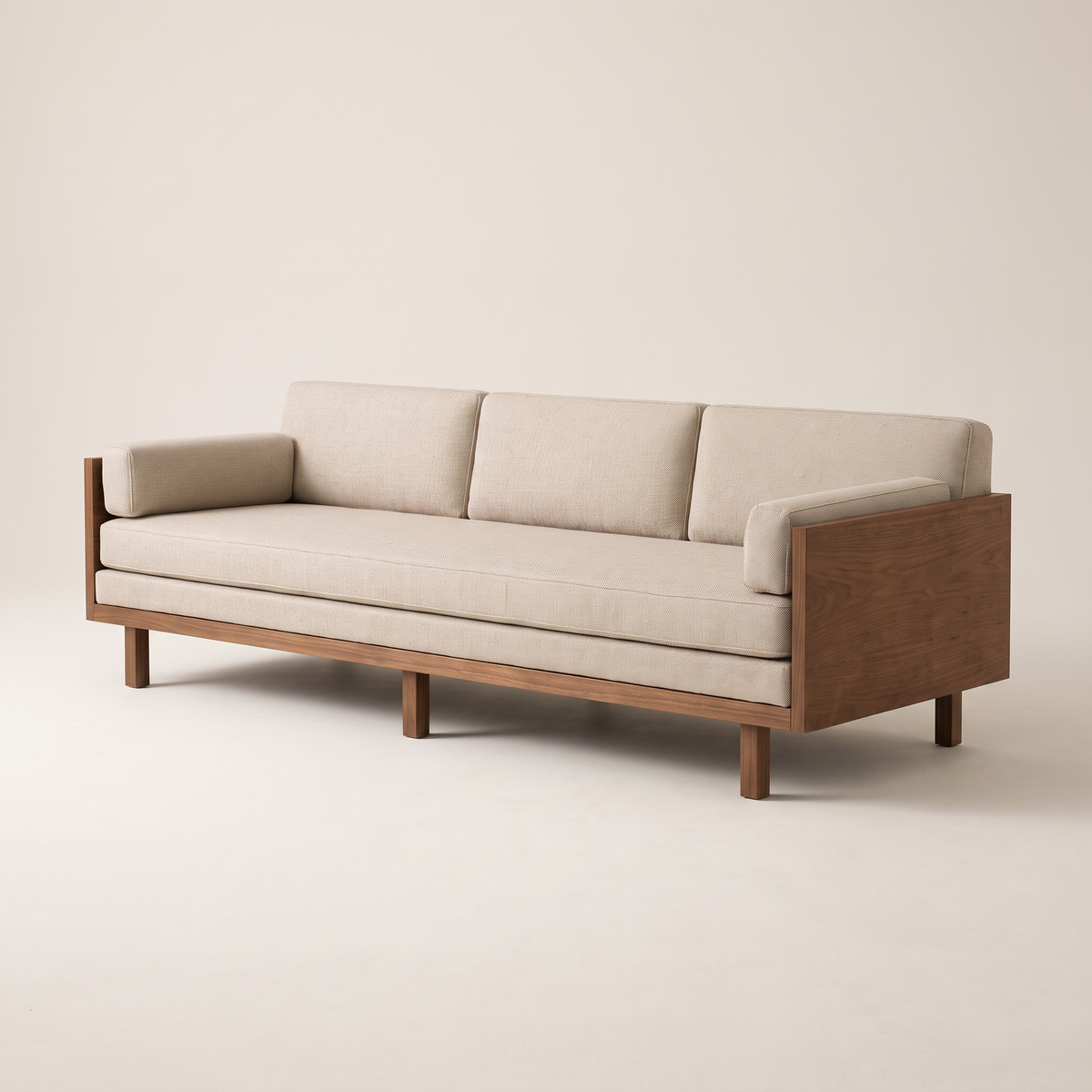 Kora Wood three-seat sofa in oatmeal upholstery with walnut veneer panel arms and square wooden legs, front three-quarter view