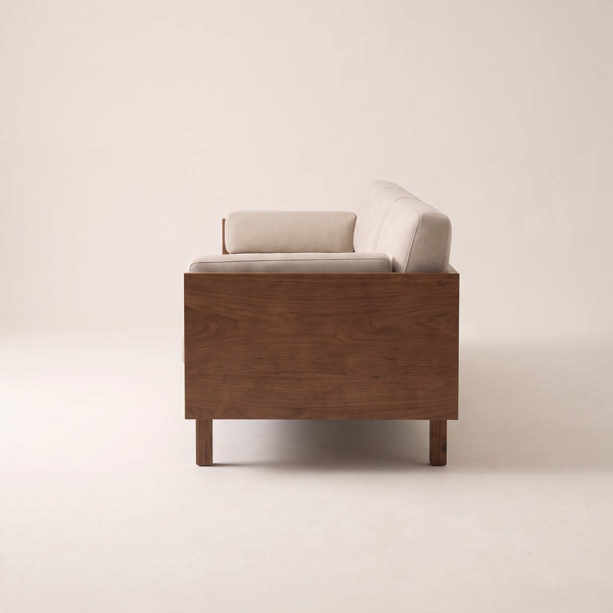 Kora Wood sofa walnut veneer side panel and oatmeal cushions, side profile view