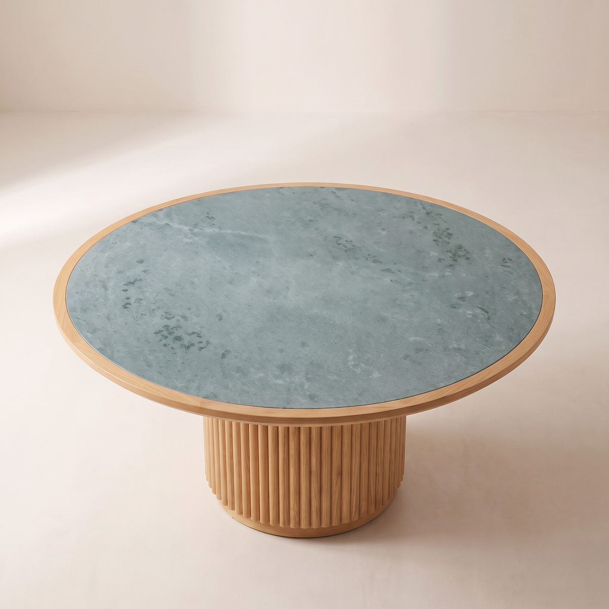 Kota Round dining table showing its round honed Kota stone top with ash rim, elevated view