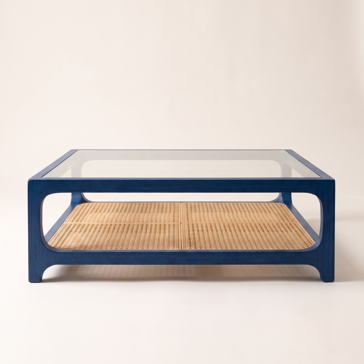 Linea Cane Blue coffee table with blue-stained ash frame, clear glass top and natural cane shelf, front elevation