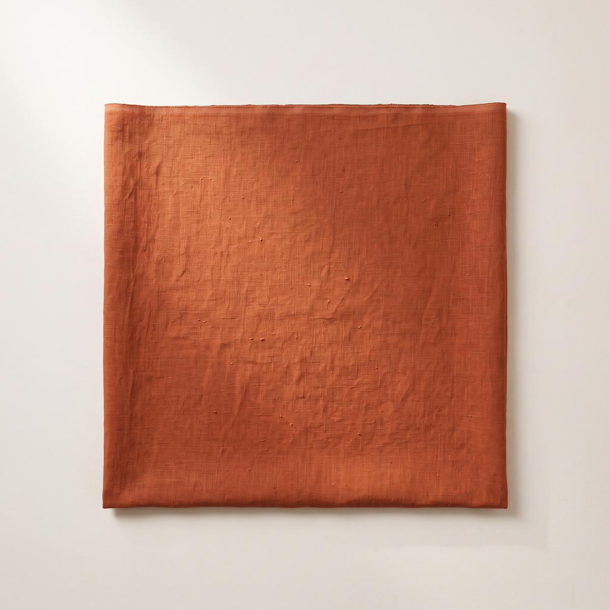 Linen Rust upholstery fabric, flat swatch seen from above showing the slubbed linen weave