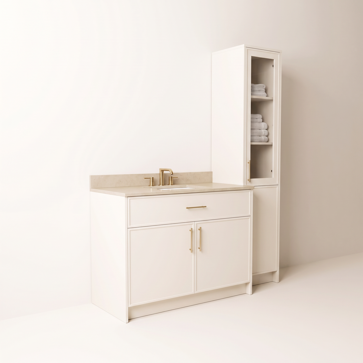 Linen Tower Vanity in ivory with brass pulls and tall towel tower, front-left three-quarter view