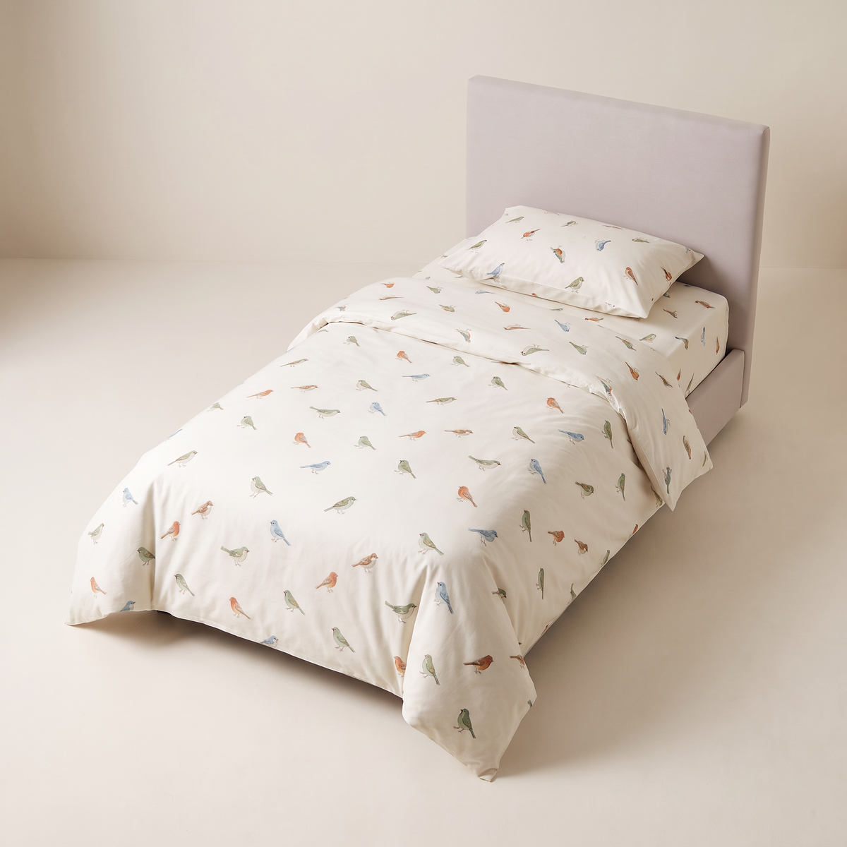 Little Flock Kids Set bird-print bedding on a single bed, elevated three-quarter view
