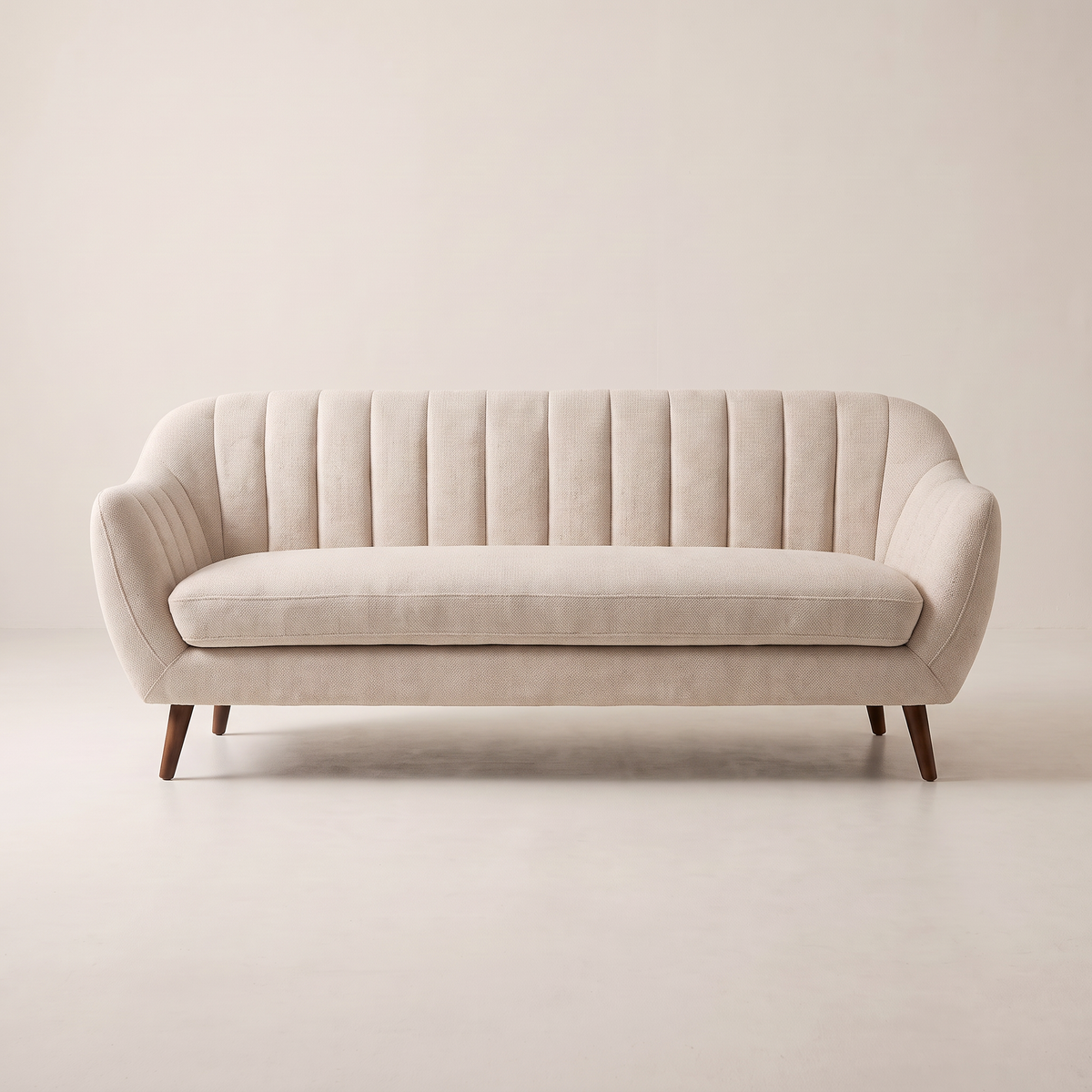 Luna Ivory sofa in ivory channel-tufted upholstery with dark tapered wooden legs, front view