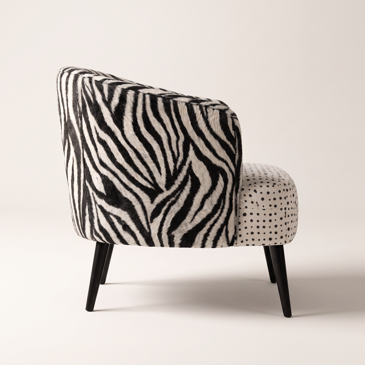 Mono Dot lounge chair in zebra-print shell with polka-dot seat and black tapered legs, side profile view