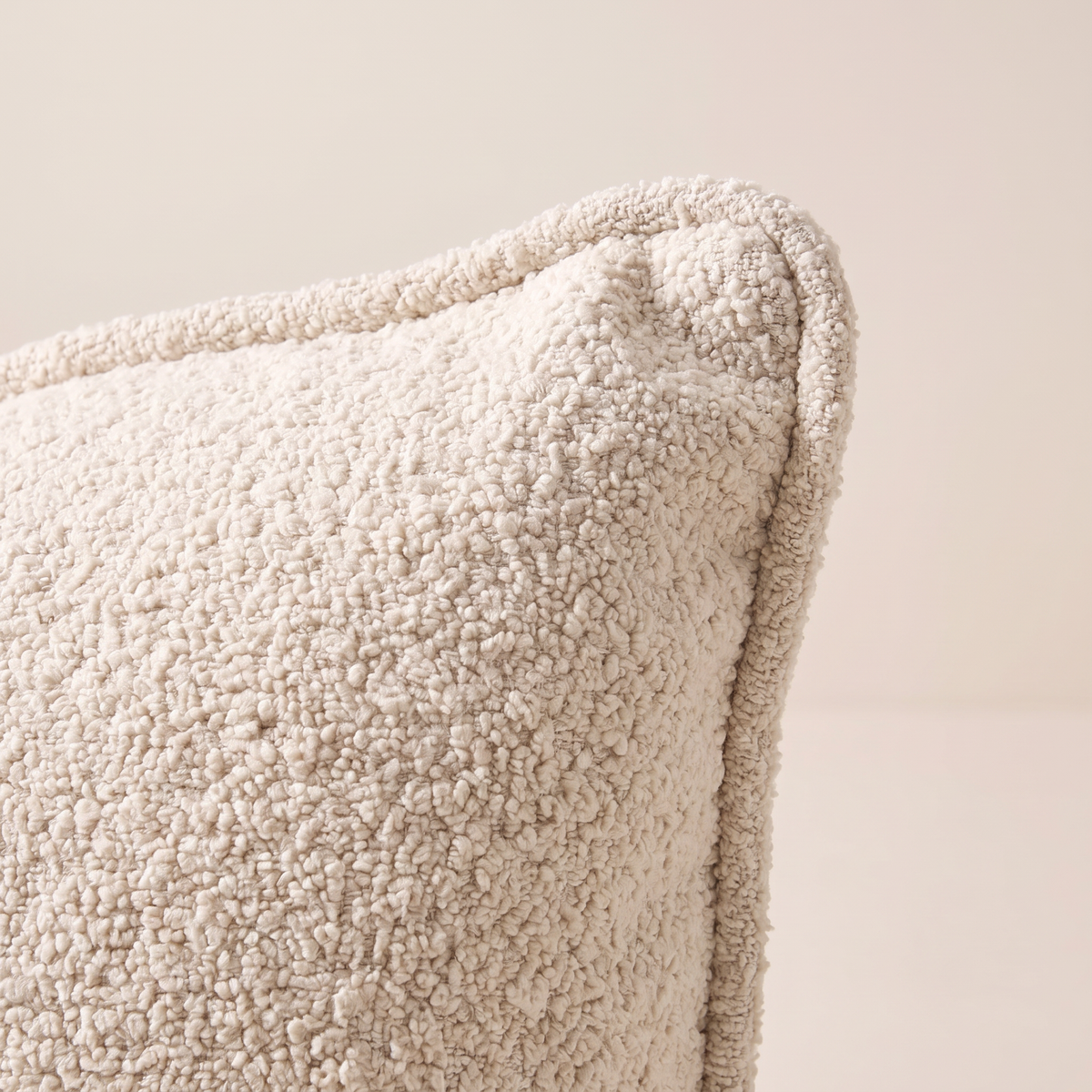 Close-up of Nimbus Bouclé Cushion corner showing bouclé loops and piped edge