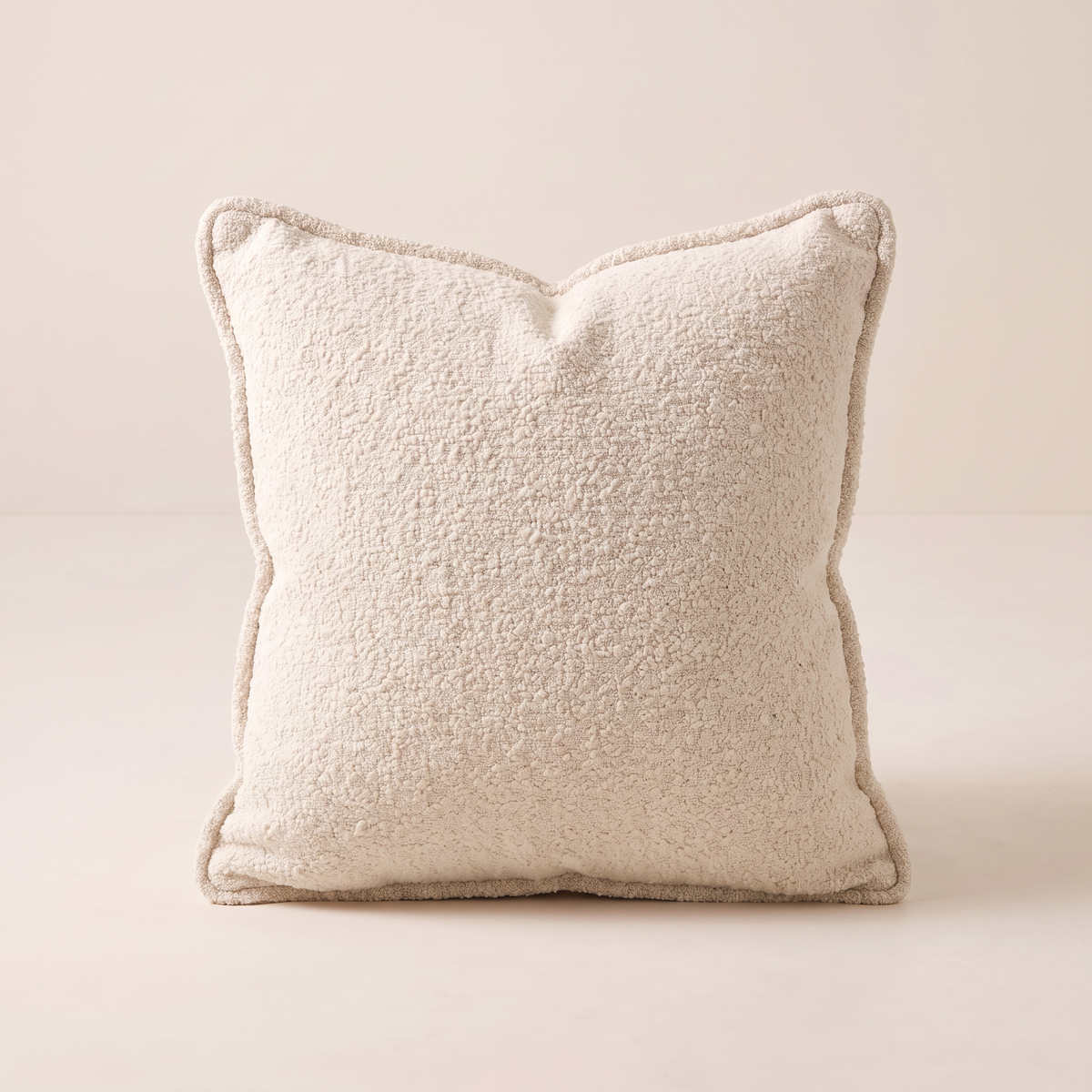 Nimbus Bouclé Cushion in ivory-cream bouclé, straight front view