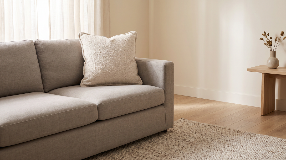 Nimbus Bouclé Cushion styled on a neutral sofa in a calm living room