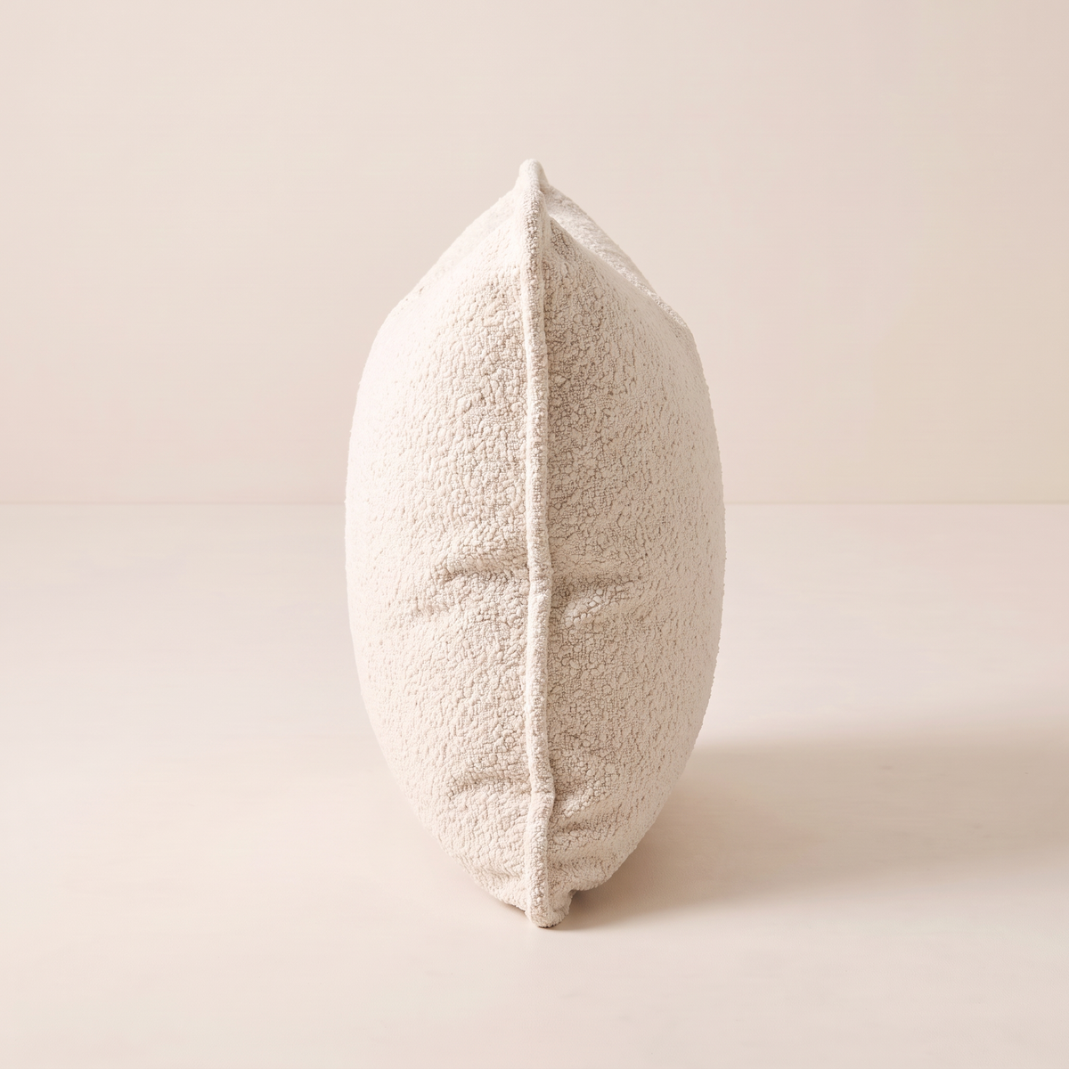 Nimbus Bouclé Cushion edge view showing plump thickness and piped seam