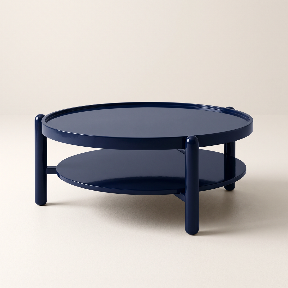 Noir Blue round two-tier coffee table in glossy navy PU finish with rounded post legs, front three-quarter view