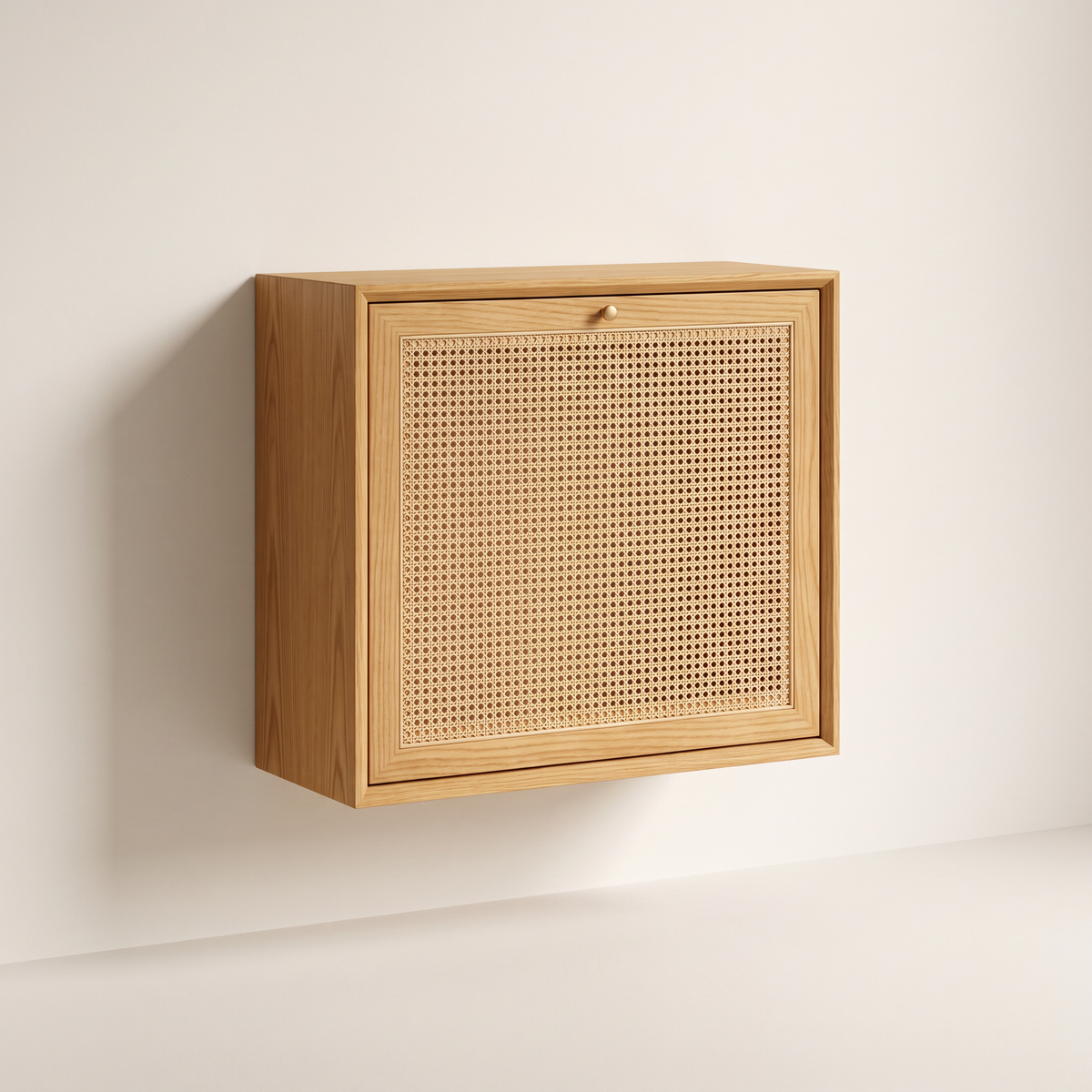 Nook Fold Desk wall-mounted honey ash cabinet with cane-panel drop-down flap and brass knob, closed, front three-quarter view