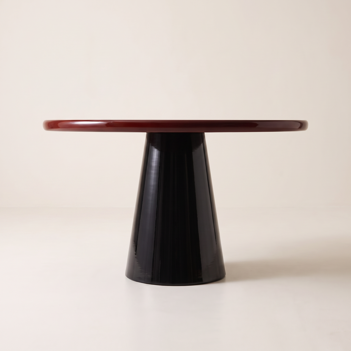 Obel round dining table with burgundy gloss top on a black conical pedestal base, side elevation