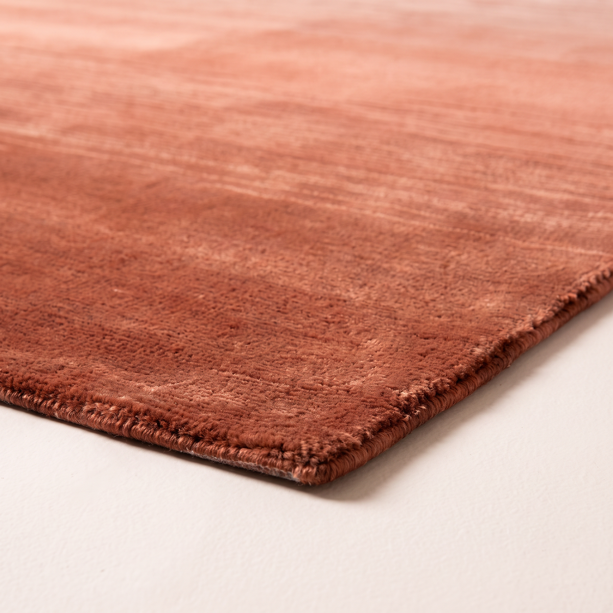Ombre Dusk Rug corner close-up showing low hand-loomed pile, sheen and bound edge