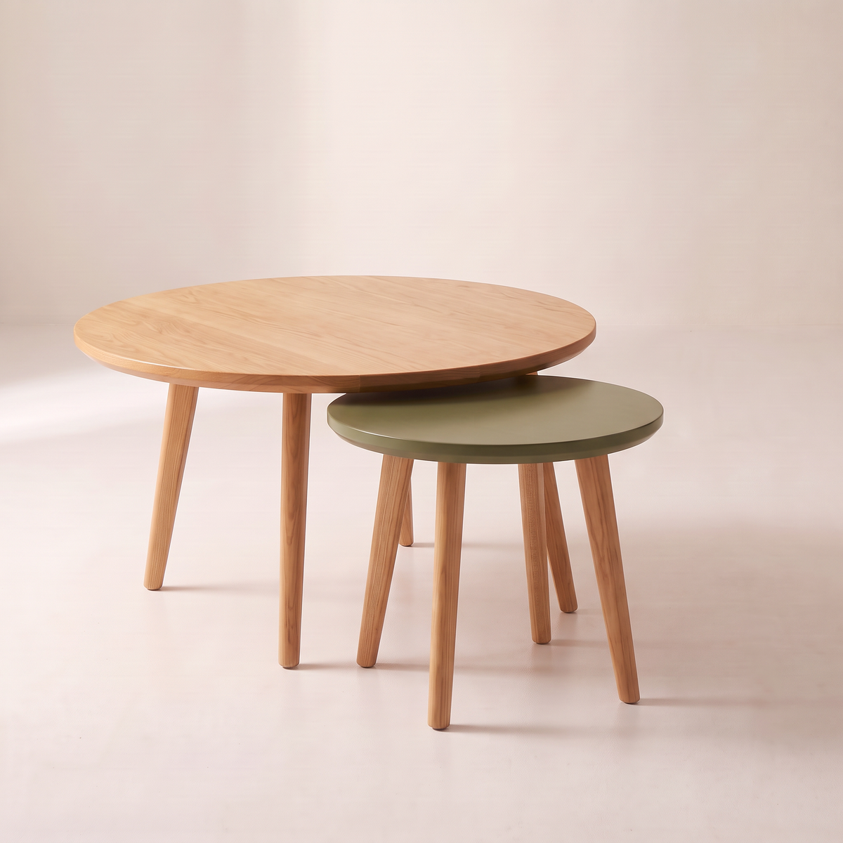 Orbit Nest nesting coffee tables with the small olive table in front, tucked under the honey ash top, front view