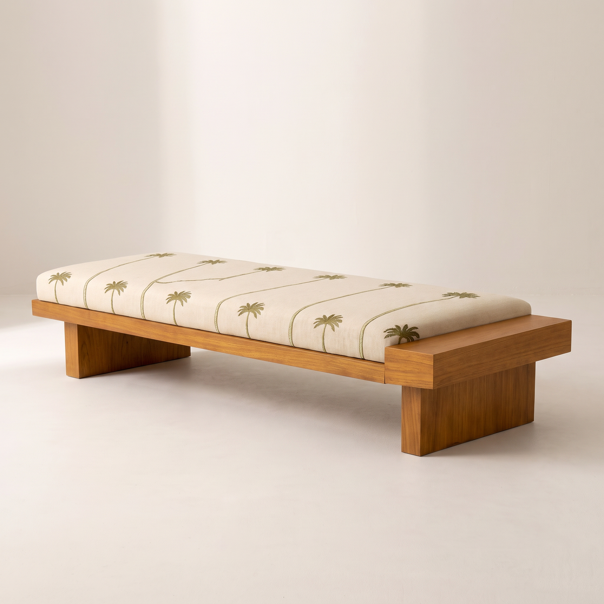 Palmira 2 low wooden platform bench with cream cushion printed with olive palm trees, front three-quarter view
