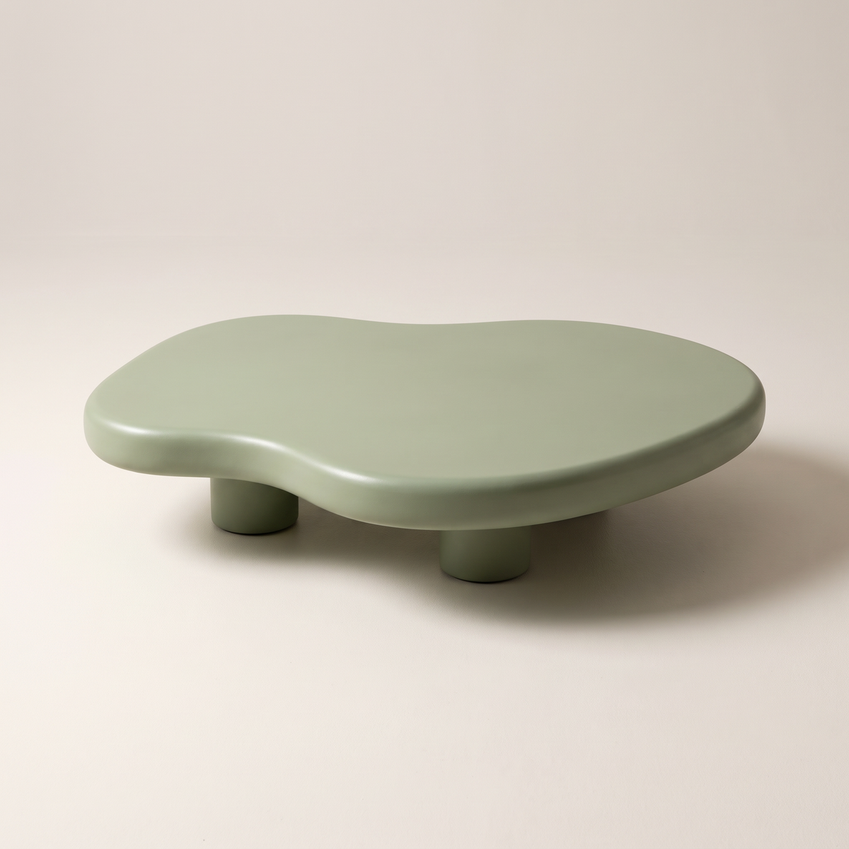 Pebble Sage low free-form coffee table in matte sage green PU finish, front three-quarter view