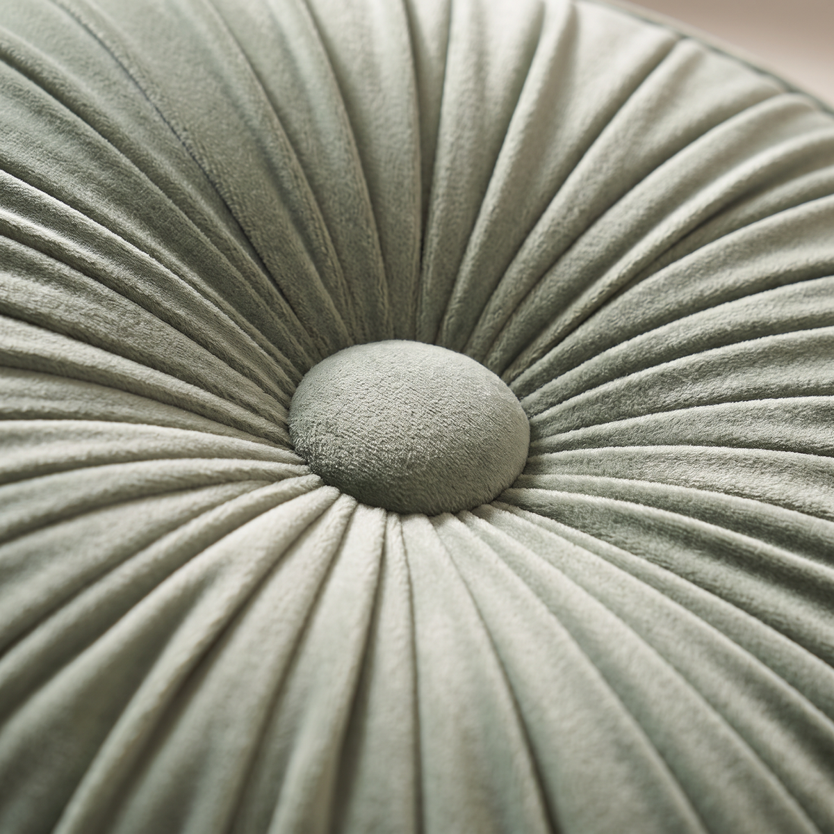 Close-up of Pinwheel Round Cushion centre button with radial velvet pleats