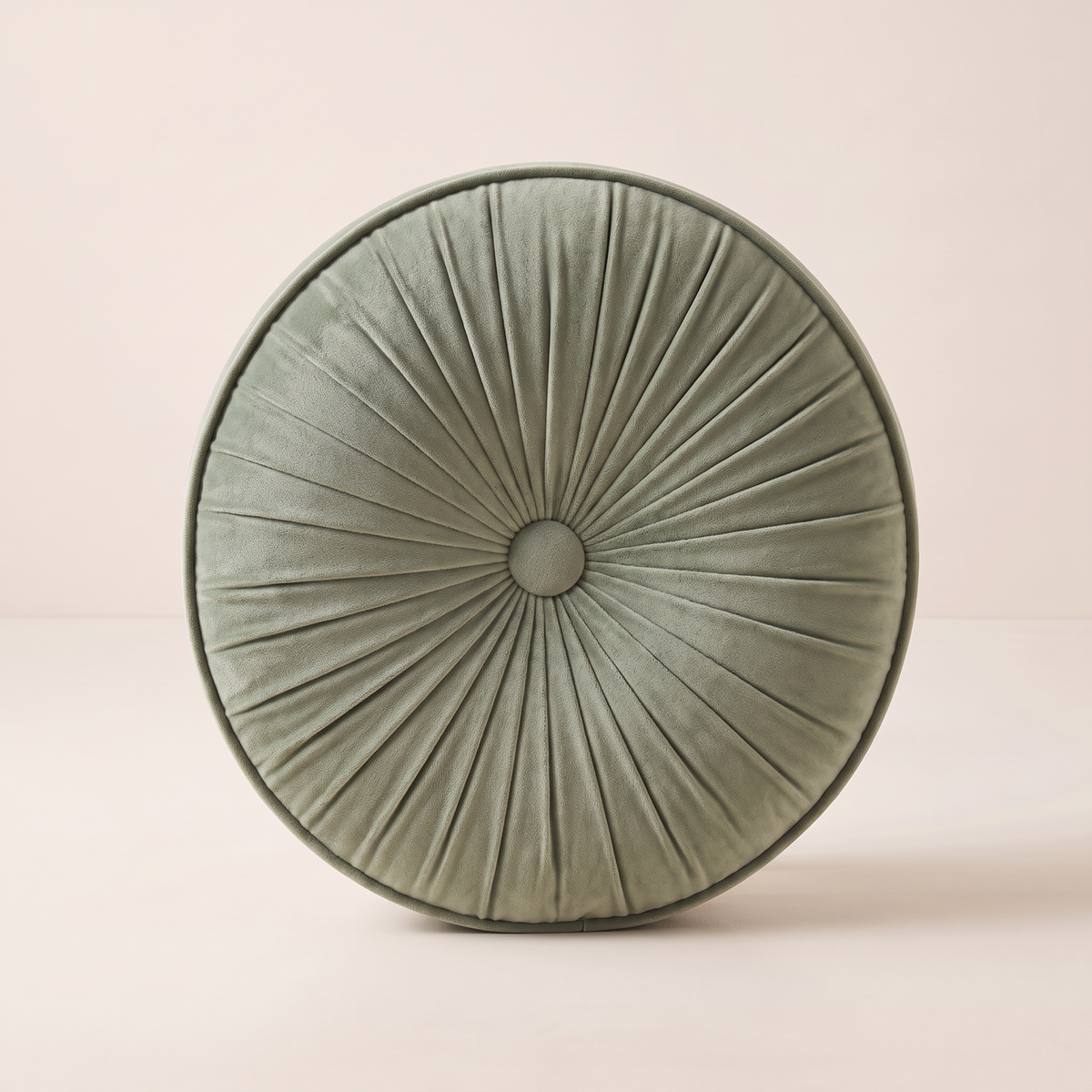 Pinwheel Round Cushion in sage velvet, straight front view of the pleated face and centre button
