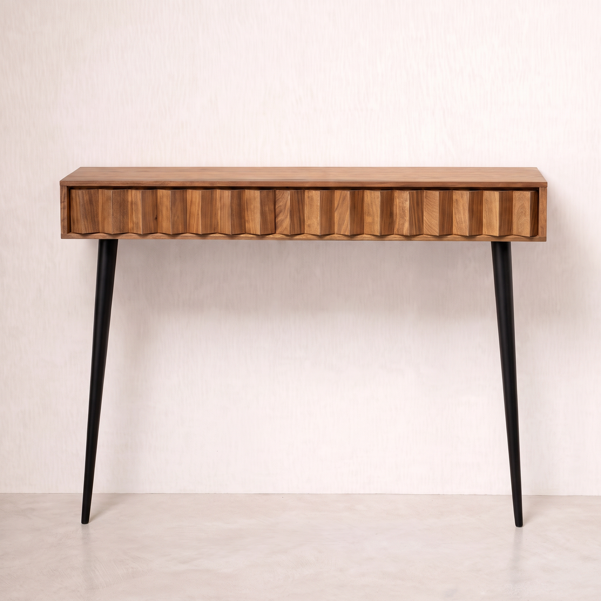 Pleat wall console in wood veneer with pleated front and two black tapered legs, front view