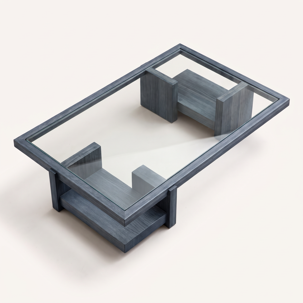 Plinth Blue glass-top coffee table in slate blue-grey wood with block plinth bases, elevated top view