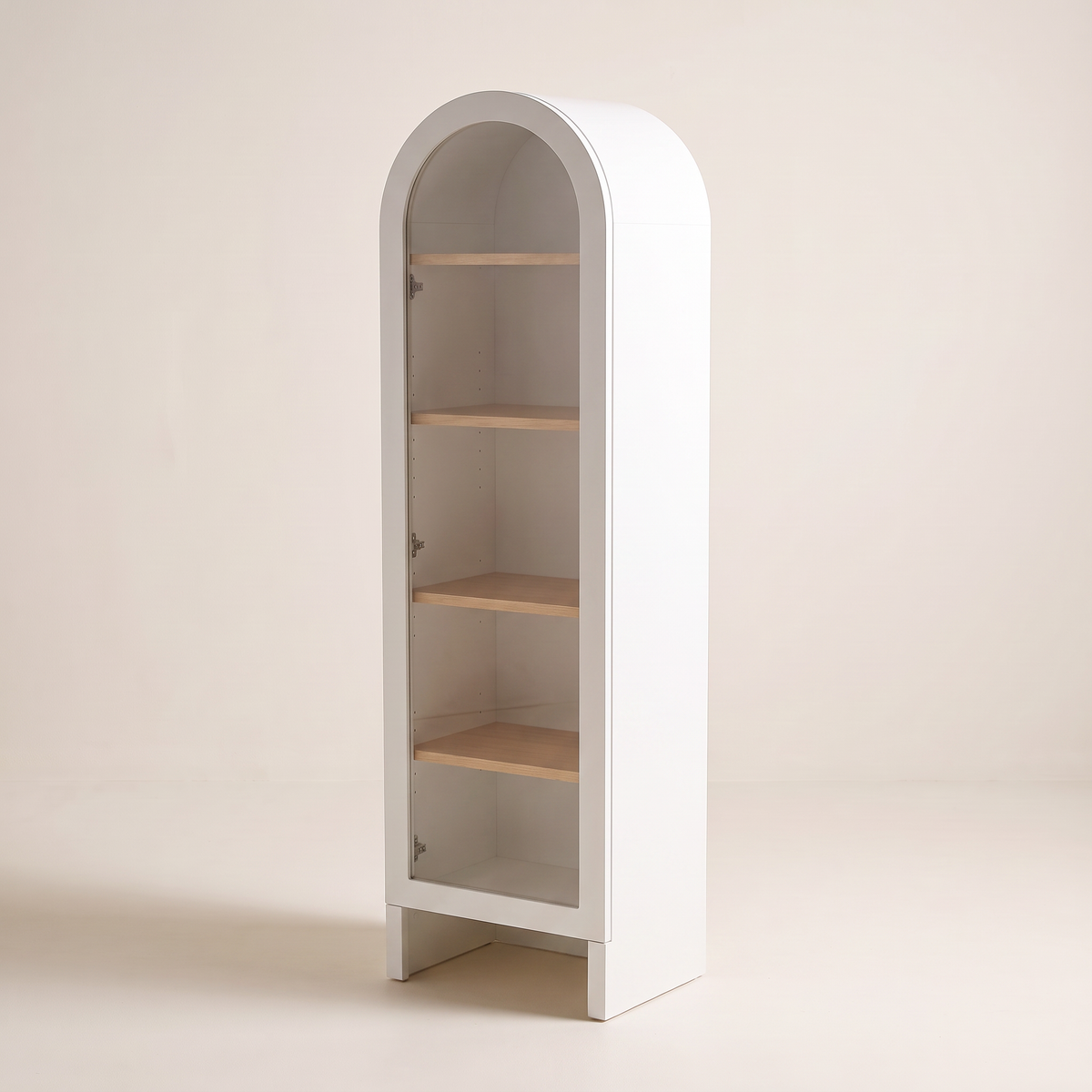 Portal Bookcase in matte white with arched top and clear glass door, front-right three-quarter view