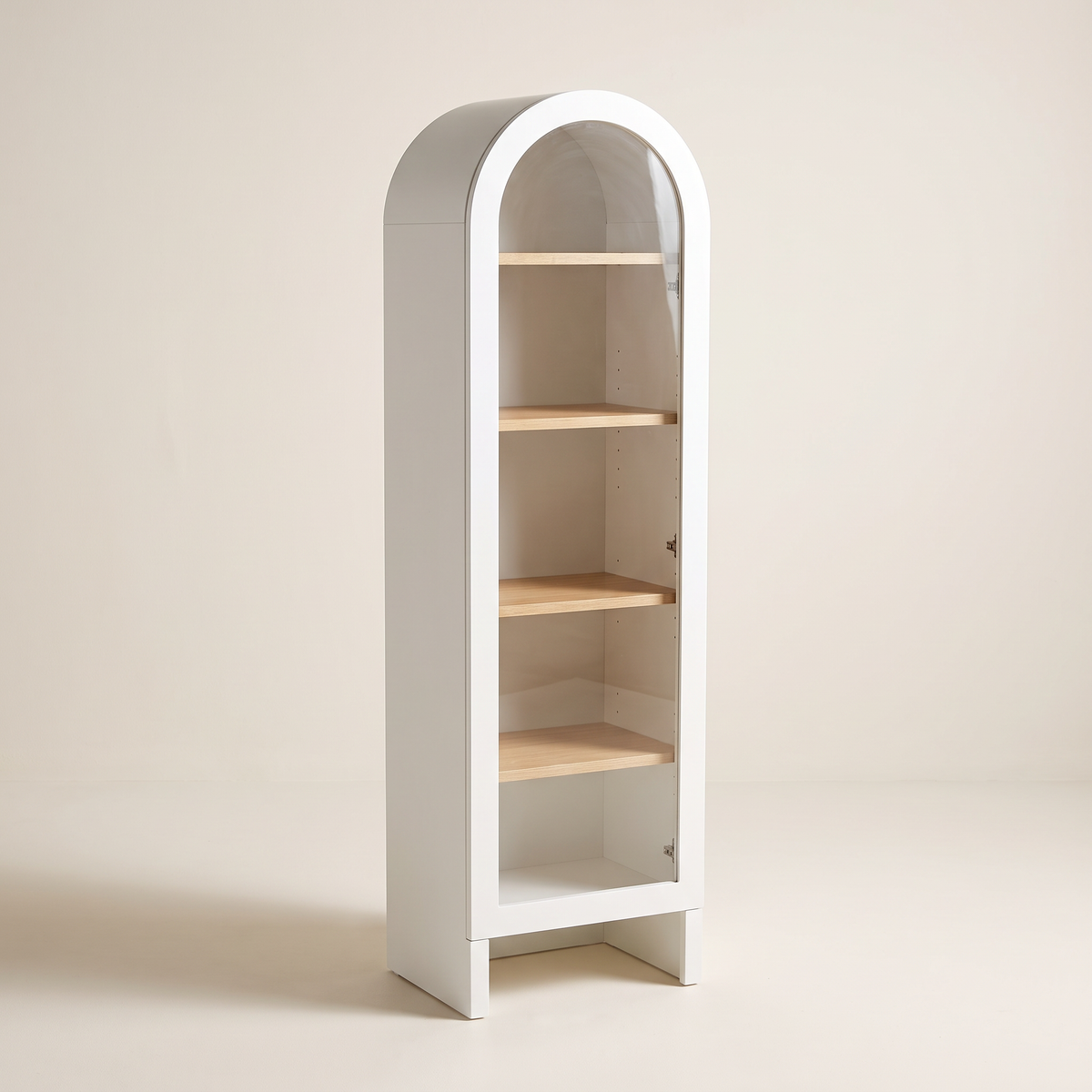 Portal Bookcase in matte white with arched top, clear glass door and light wood shelves, front three-quarter view