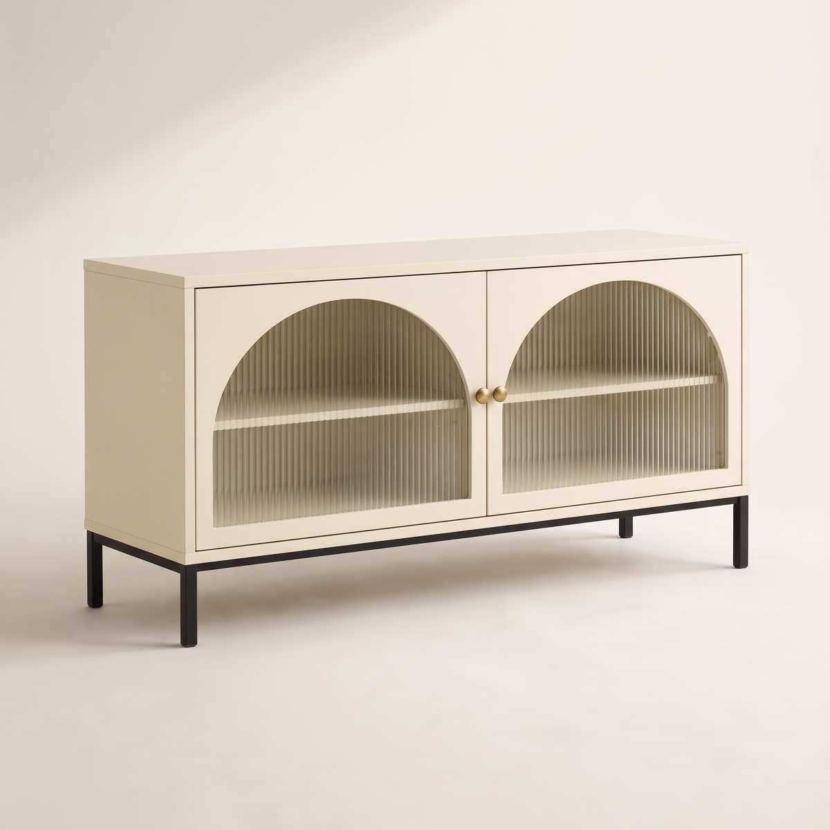 Portal Low cabinet in cream with arched reeded-glass doors, brass knobs and black metal base, front three-quarter view