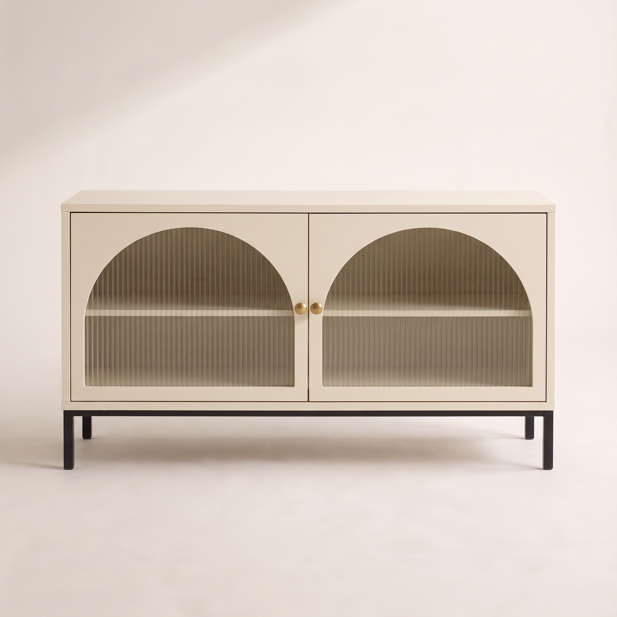 Portal Low cabinet in cream with arched reeded-glass doors, brass knobs and black metal base, front view