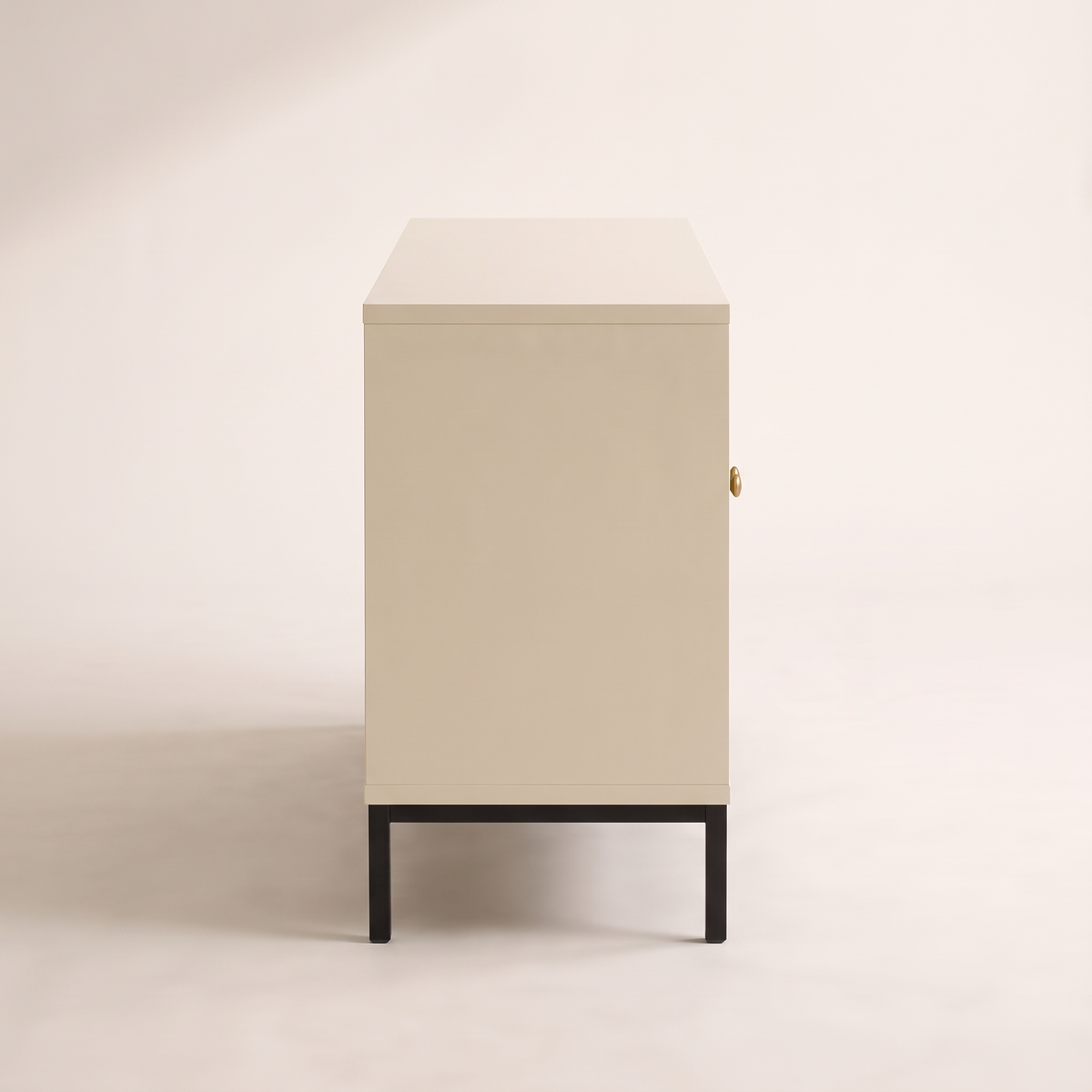 Portal Low cabinet in cream with black metal base, side profile view