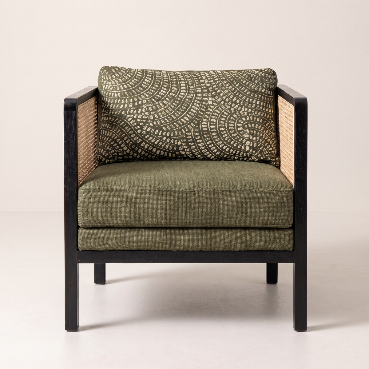 Raffia Black lounge chair, straight front view with olive seat cushion and patterned back cushion