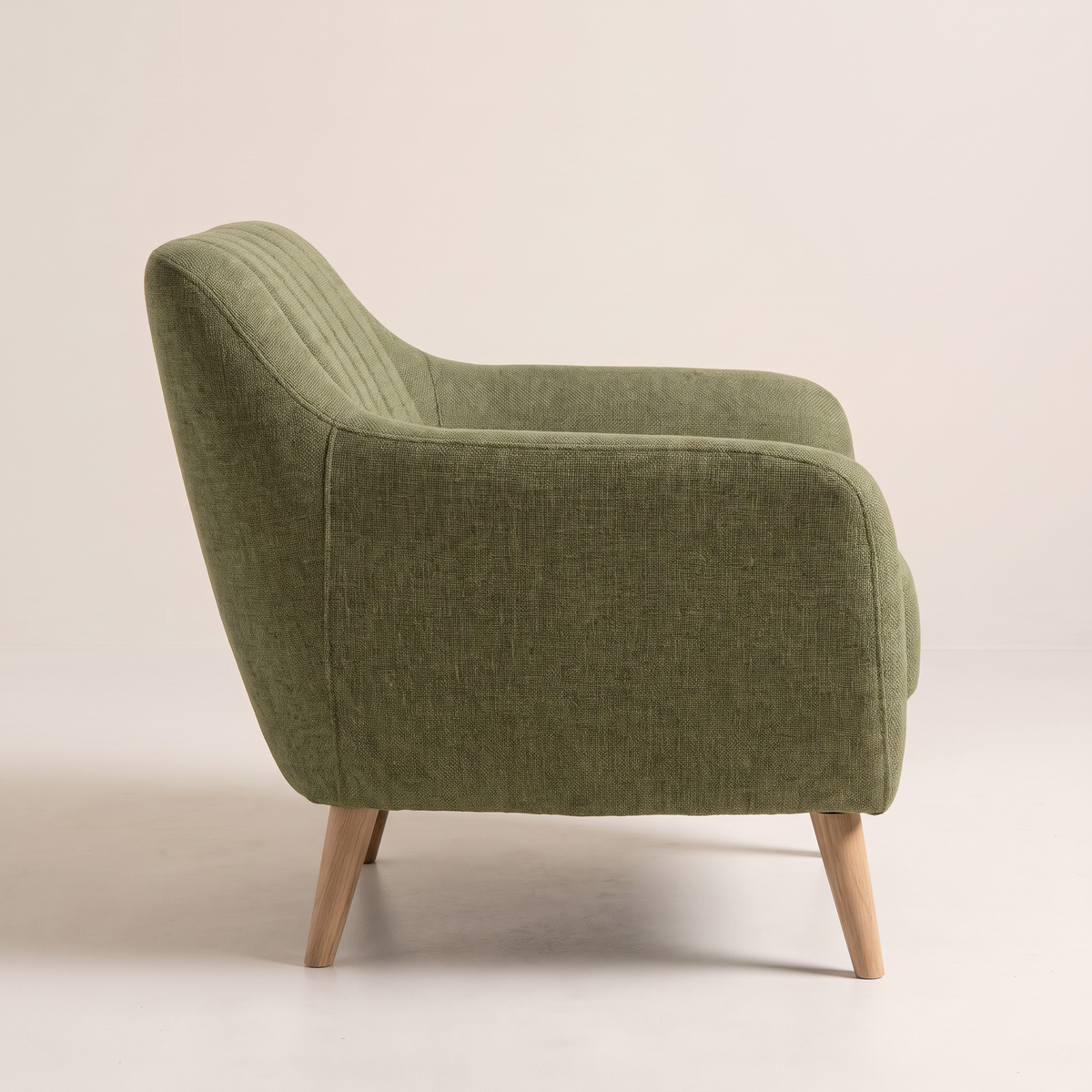 Rest Green lounge chair in olive green upholstery with natural wood tapered legs, side profile view