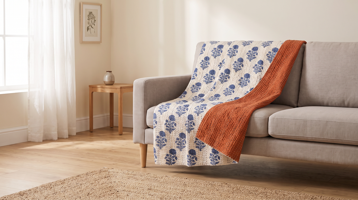 Reversible Kantha Throw draped over a neutral sofa in a calm living room