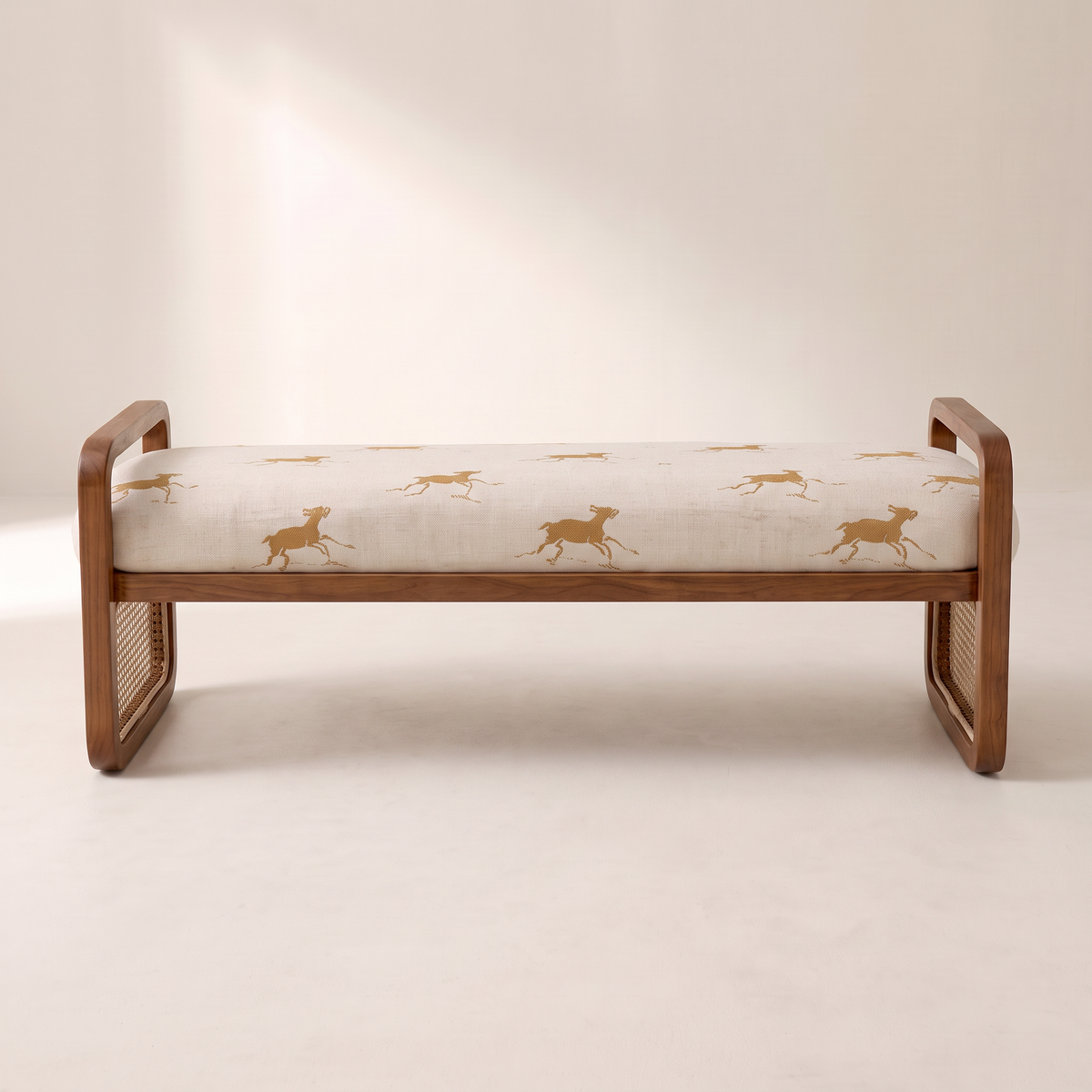 Serena Canter ottoman bench in cream galloping-horse print with walnut frame, front elevation