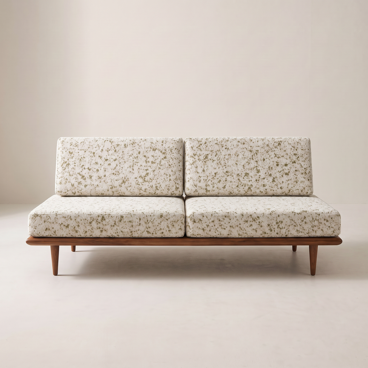 Slat Ivory armless sofa in ivory speckled upholstery on a walnut-tone wooden platform, front view
