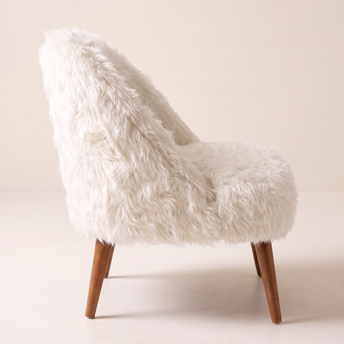 Soft Cloud lounge chair, side profile showing the curved back and splayed legs