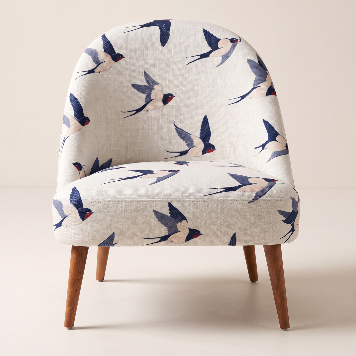 Soft Flight lounge chair, straight front view of the swallow-print seat and back