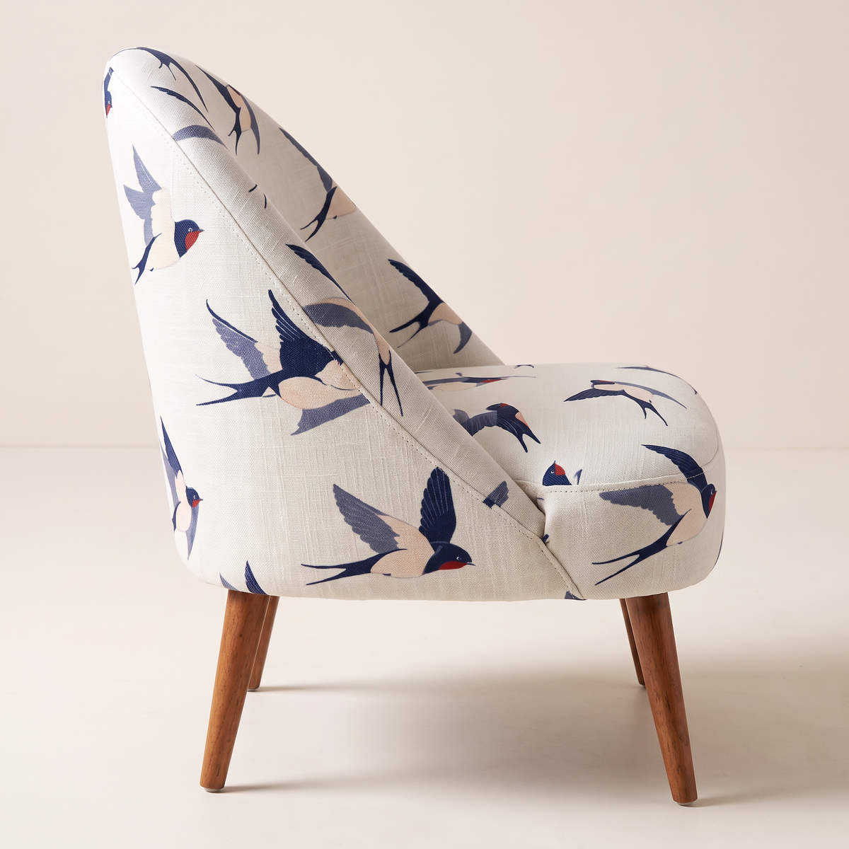 Soft Flight lounge chair, side profile showing the curved back and splayed legs