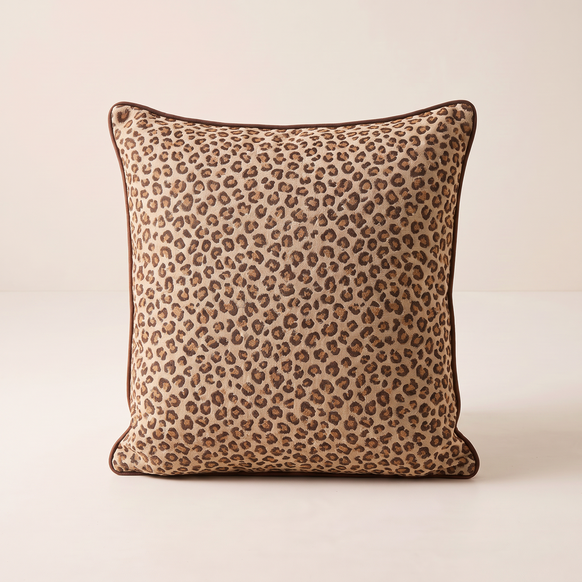 Spot Jacquard Cushion in leopard jacquard with chocolate piping, straight front view