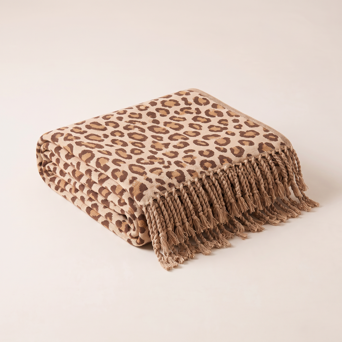 Spotted Fringe Throw in leopard cotton jacquard, folded neatly with knotted fringe showing