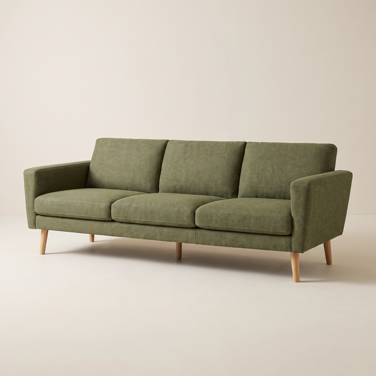 Stay Olive sofa in olive woven upholstery with tapered wooden legs, front three-quarter view