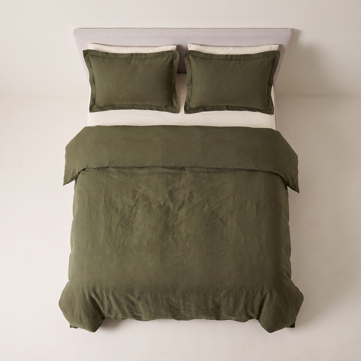 Stonewash Olive Duvet Set deep olive linen-cotton duvet and shams, view from the foot of the bed