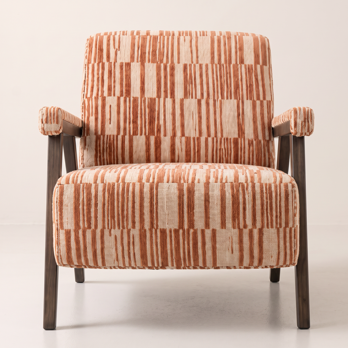Strata Red lounge chair in cream and rust striped fabric with slim dark wooden frame, front view